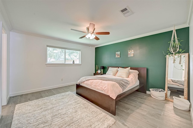 5806 Cartagena St, Houston, TX 77035 - bedroom with baseboards, visible vents, crown molding, and light wood-style flooring