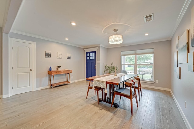 5806 Cartagena St, Houston, TX 77035 - dining area featuring baseboards, visible vents, crown molding, and light wood finished floors
