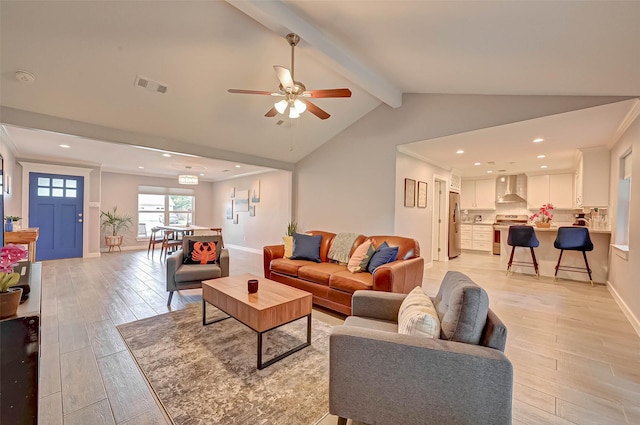5806 Cartagena St, Houston, TX 77035 - living area with a ceiling fan, lofted ceiling with beams, baseboards, visible vents, and light wood-style floors