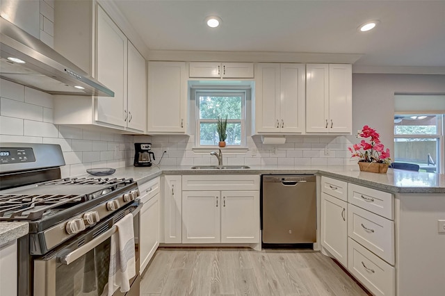 5806 Cartagena St, Houston, TX 77035 - kitchen featuring a sink, range hood, white cabinetry, a peninsula, and stainless steel appliances
