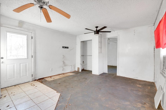 2320 Westward Ave, La Marque, TX 77568 - unfurnished room featuring a textured ceiling, a ceiling fan, and unfinished concrete floors