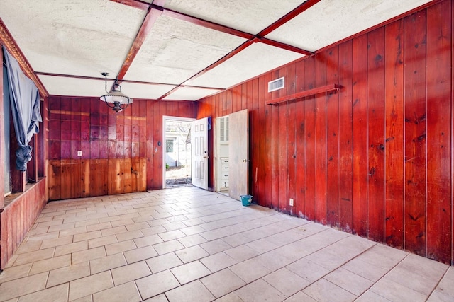 2320 Westward Ave, La Marque, TX 77568 - interior space featuring wood walls, visible vents, and a textured ceiling