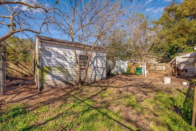2320 Westward Ave, La Marque, TX 77568 - view of yard featuring a fenced backyard, a storage unit, and an outdoor structure