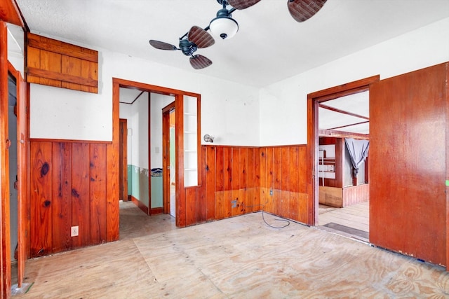 2320 Westward Ave, La Marque, TX 77568 - unfurnished room featuring wood walls, wainscoting, and a ceiling fan