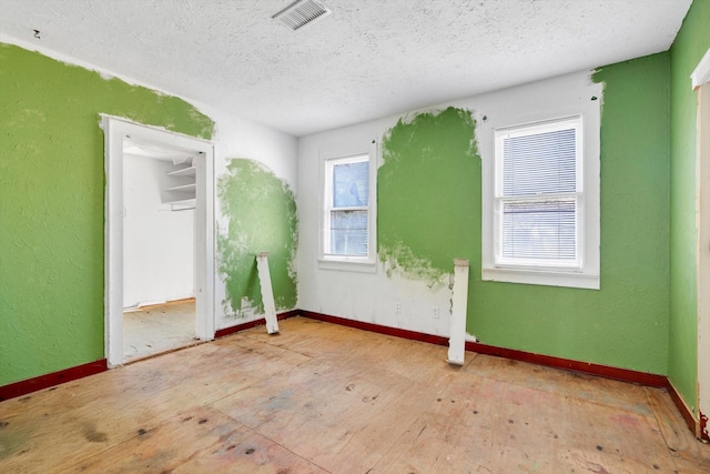 2320 Westward Ave, La Marque, TX 77568 - empty room featuring plenty of natural light, visible vents, a textured ceiling, and baseboards