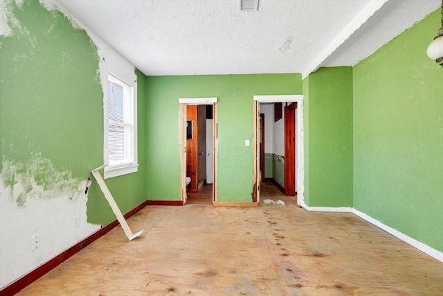 2320 Westward Ave, La Marque, TX 77568 - unfurnished bedroom with visible vents, baseboards, a closet, and a textured ceiling
