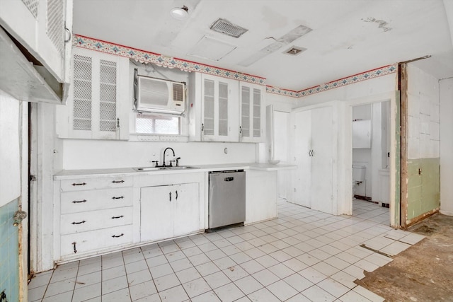 2320 Westward Ave, La Marque, TX 77568 - kitchen with stainless steel dishwasher, glass insert cabinets, white cabinets, and light countertops