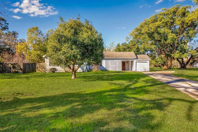 2320 Westward Ave, La Marque, TX 77568 - view of yard featuring driveway, a garage, and fence