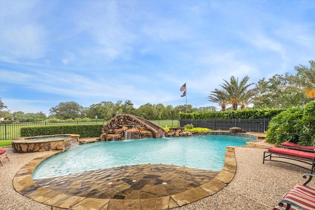 view of swimming pool featuring a pool with connected hot tub, a fenced backyard, and a patio area