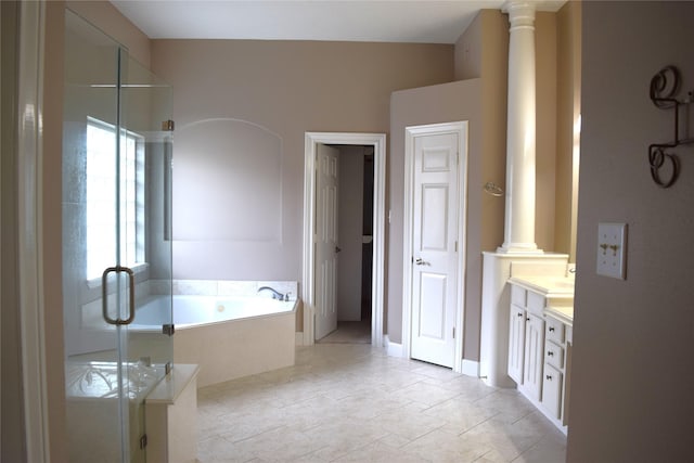 bathroom featuring a bath, vanity, ornate columns, and a stall shower