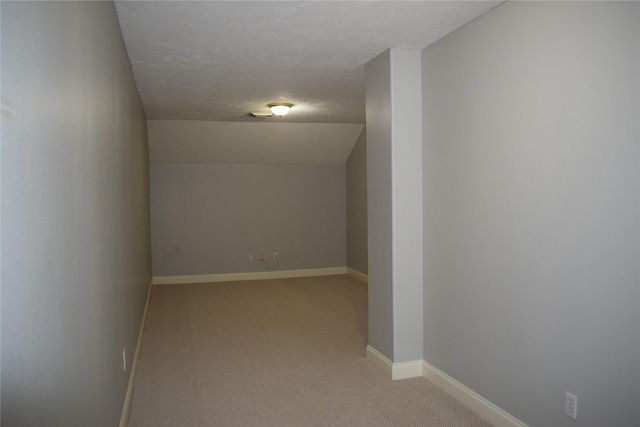 interior space with baseboards and light carpet