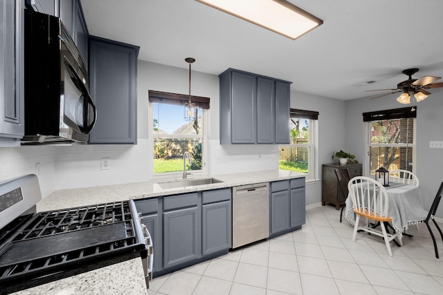 8922 Eaglecove Dr, Houston, TX 77064 - kitchen with appliances with stainless steel finishes, ceiling fan, a sink, and a wealth of natural light