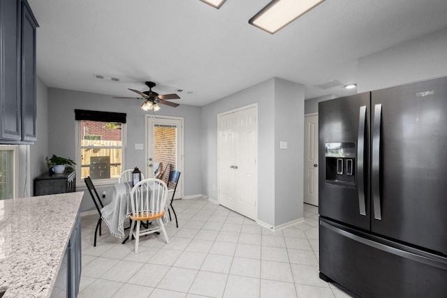 8922 Eaglecove Dr, Houston, TX 77064 - kitchen with a ceiling fan, visible vents, light tile patterned flooring, stainless steel fridge, and baseboards