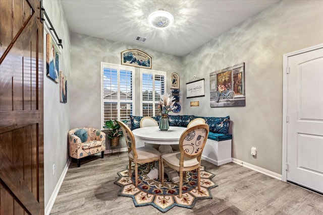 9791 Waller St, Conroe, TX 77303 - dining room featuring visible vents, baseboards, and wood finished floors