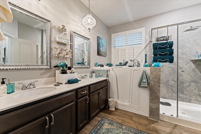 9791 Waller St, Conroe, TX 77303 - bathroom featuring double vanity, a sink, a stall shower, and wood finished floors