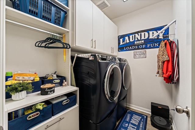 9791 Waller St, Conroe, TX 77303 - laundry room featuring visible vents, washer and clothes dryer, baseboards, and cabinet space