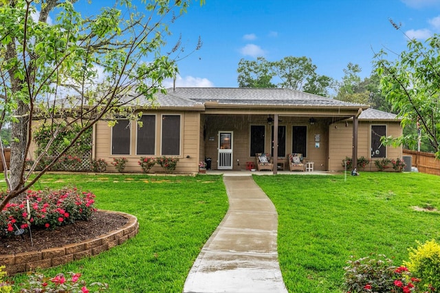 9791 Waller St, Conroe, TX 77303 - view of front of home featuring a patio area, roof with shingles, fence, and a front lawn