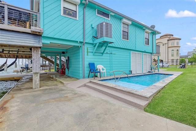 1222 Oahu Dr, Galveston, TX 77554 - back of property featuring fence, a carport, a patio, a lawn, and central AC