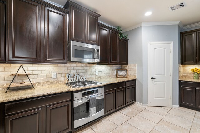 kitchen featuring visible vents, ornamental molding, dark brown cabinets, appliances with stainless steel finishes, and light tile patterned floors