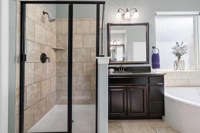 full bath with tile patterned floors, vanity, a stall shower, and a garden tub