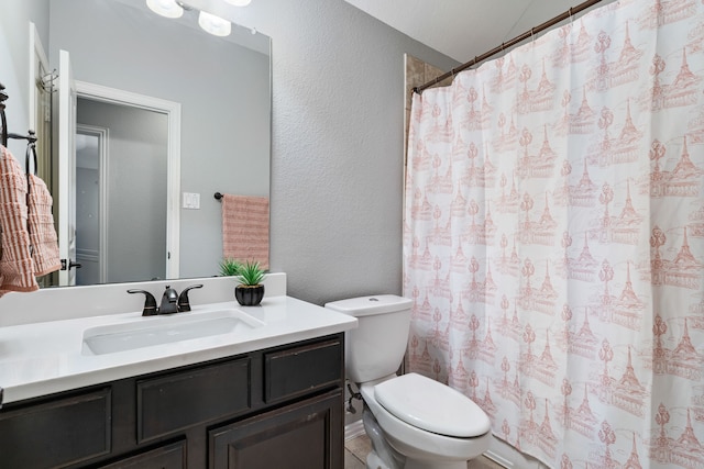 full bathroom with a shower with curtain, toilet, vanity, and a textured wall