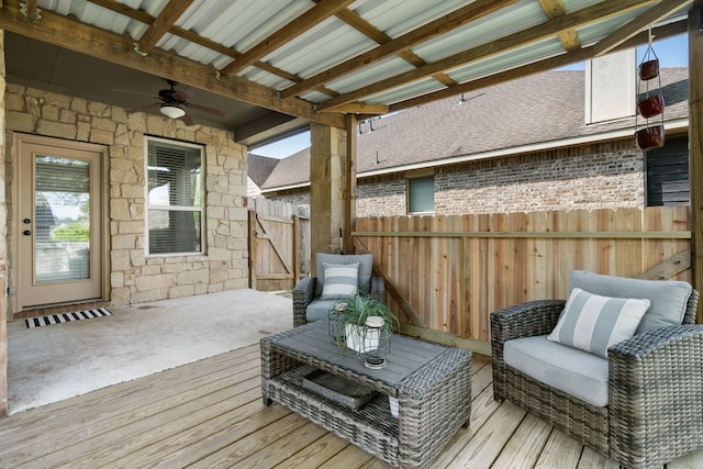 wooden deck with a ceiling fan, an outdoor living space, and fence