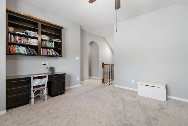 home office with arched walkways, carpet flooring, lofted ceiling, and baseboards