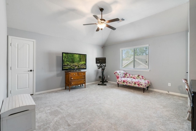 sitting room with vaulted ceiling, carpet flooring, baseboards, visible vents, and ceiling fan