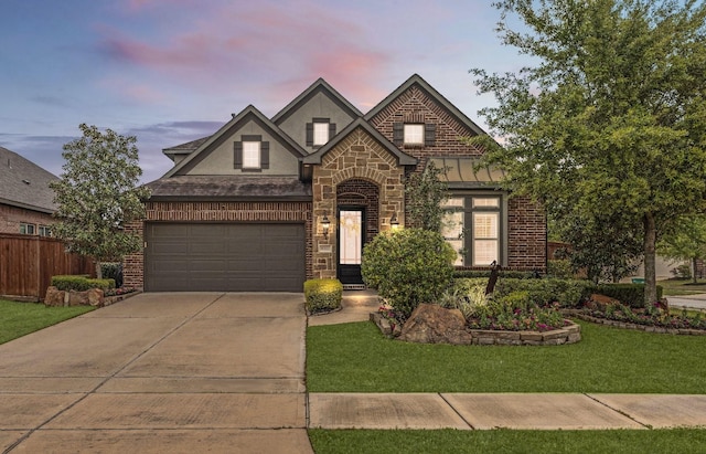 11202 Puckett River Dr, Cypress, TX 77433 - view of front of home with driveway, a garage, stone siding, and brick siding