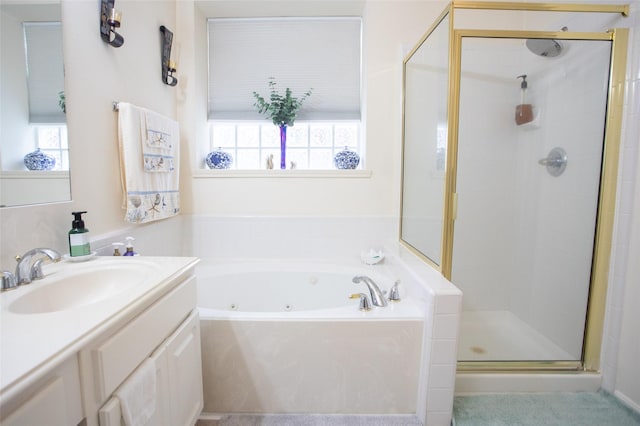 full bath featuring plenty of natural light, a stall shower, a tub with jets, and vanity
