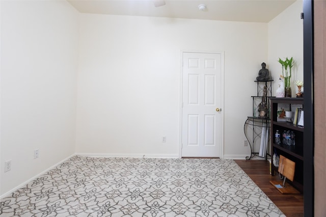 spare room featuring baseboards and a smoke detector