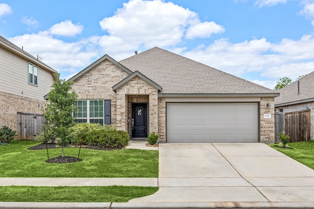 traditional home featuring brick siding, fence, driveway, and a garage