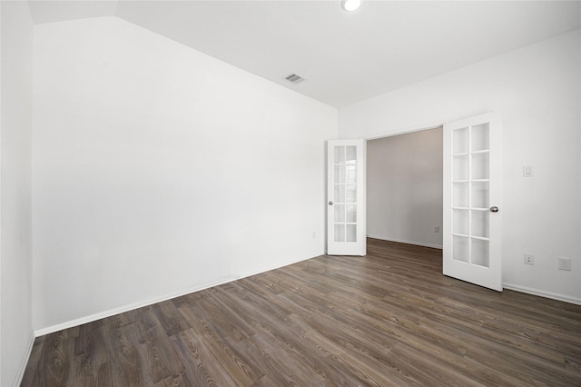 spare room with french doors, dark wood-style flooring, baseboards, visible vents, and lofted ceiling