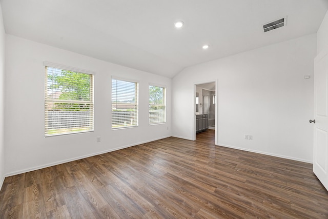 spare room featuring recessed lighting, lofted ceiling, dark wood-style floors, visible vents, and baseboards