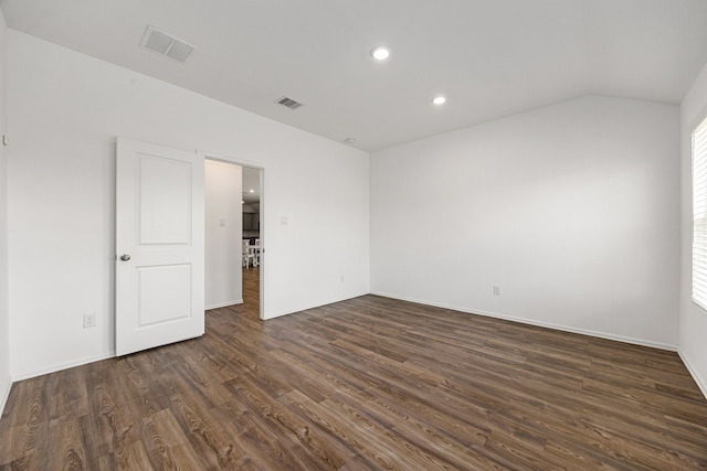 spare room with recessed lighting, lofted ceiling, visible vents, and dark wood-style floors