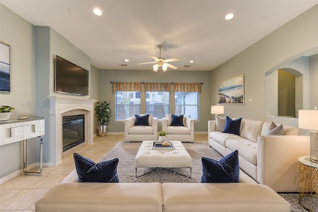 13214 Dusty Grove Ln, Sugar Land, TX 77498 - living area with recessed lighting, light tile patterned floors, ceiling fan, baseboards, and a glass covered fireplace