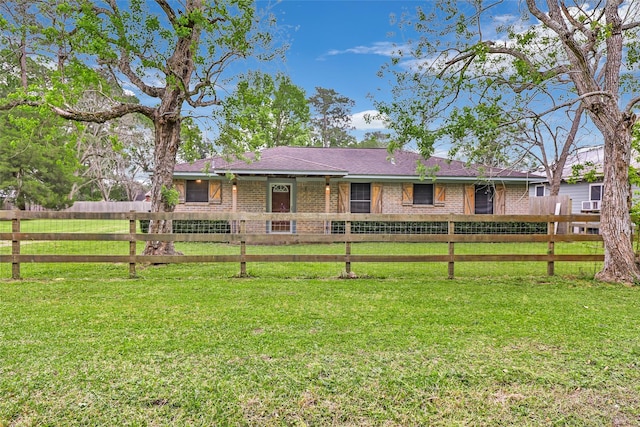 507 E Linney St, Dayton, TX 77535 - back of house featuring brick siding, fence, a shingled roof, and a yard