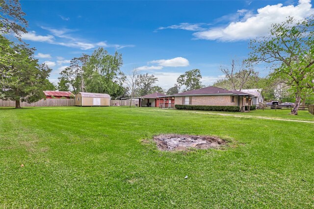 507 E Linney St, Dayton, TX 77535 - view of yard with a shed, an outbuilding, and fence