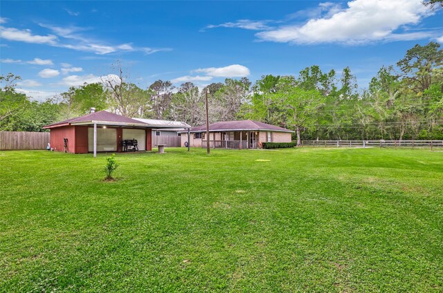 507 E Linney St, Dayton, TX 77535 - view of yard featuring an outdoor structure, a pole building, and fence