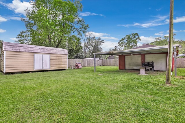 507 E Linney St, Dayton, TX 77535 - view of yard with an outbuilding, fence, a garage, and a shed
