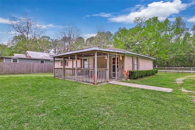 507 E Linney St, Dayton, TX 77535 - back of house with a lawn, brick siding, and a fenced backyard
