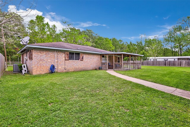 507 E Linney St, Dayton, TX 77535 - view of front of property featuring a front yard, cooling unit, brick siding, and fence private yard