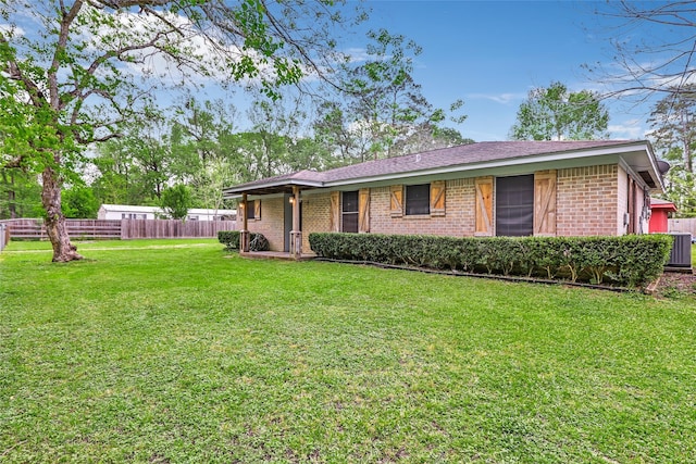507 E Linney St, Dayton, TX 77535 - exterior space featuring a yard, brick siding, and fence