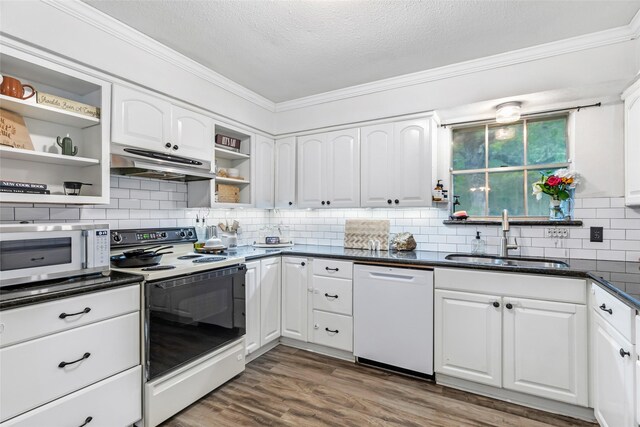 507 E Linney St, Dayton, TX 77535 - kitchen featuring a sink, open shelves, wood finished floors, under cabinet range hood, and white appliances