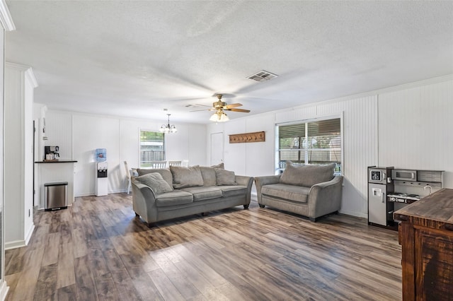 507 E Linney St, Dayton, TX 77535 - living room featuring dark wood-style floors, visible vents, ceiling fan with notable chandelier, and a textured ceiling