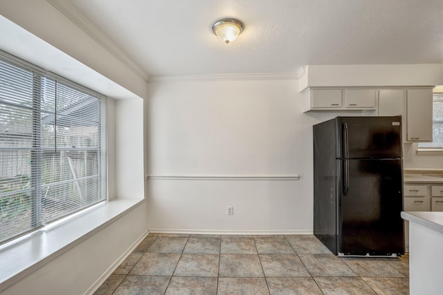 23123 Lestergate Dr, Spring, TX 77373 - kitchen featuring freestanding refrigerator, light countertops, crown molding, and baseboards