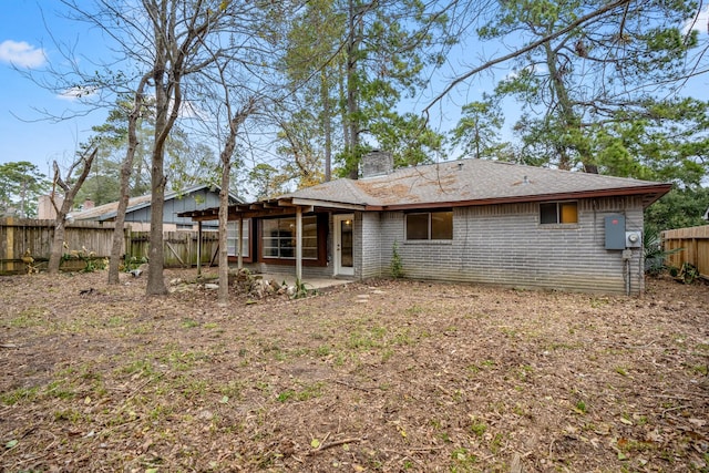 23123 Lestergate Dr, Spring, TX 77373 - rear view of property featuring a chimney, a fenced backyard, a patio, and brick siding