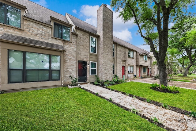 6506 Kentwick Dr, Houston, TX 77084 - view of property featuring a chimney, a shingled roof, and a front lawn