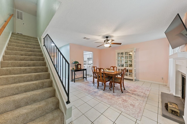6506 Kentwick Dr, Houston, TX 77084 - dining space featuring stairs, visible vents, ceiling fan, and light tile patterned floors
