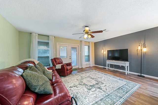 6506 Kentwick Dr, Houston, TX 77084 - living area featuring a wealth of natural light, french doors, wood finished floors, visible vents, and ceiling fan